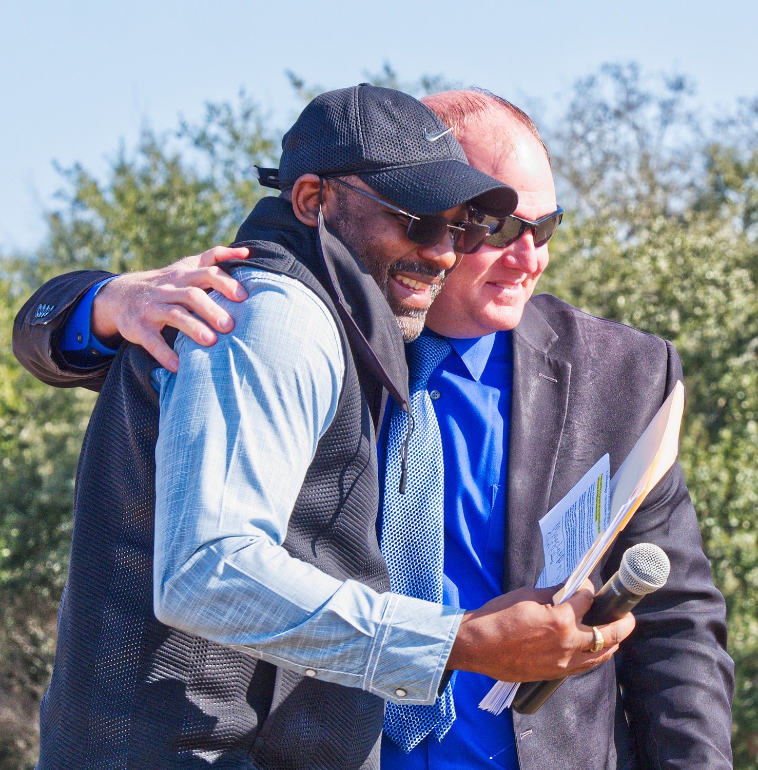 "Brothers from another mother," pastors Demethrius Boyd (left) and Michael Mize embrace after Mize's passionate words. [prints available]